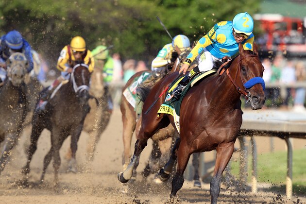 LOUISVILLE, KY - MAY 02:  American Pharoah #18, ridden by Victor Espinoza, comes out of turn 4 during the 141st running of the Kentucky Derby at Churchill Downs on May 2, 2015 in Louisville, Kentucky.  (Photo by Andy Lyons/Getty Images)