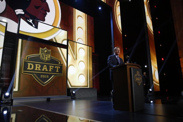 NFL commissioner Roger Goodell announces after the Washington Redskins selects Iowa offensive lineman Brandon Scherff as the fifth pick in the first round of the 2015 NFL Draft,  Thursday, April 30, 2015, in Chicago. (AP Photo/Charles Rex Arbogast)