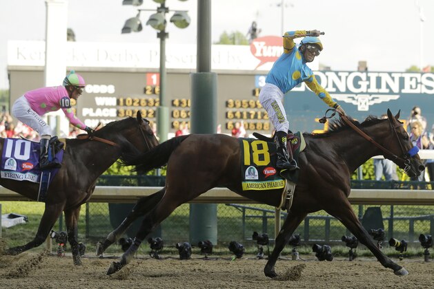 Victor Espinoza rides American Pharoah to victory in the 141st running of the Kentucky Derby horse race at Churchill Downs Saturday, May 2, 2015, in Louisville, Ky. (AP Photo/Morry Gash)