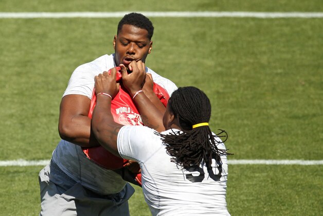 Corey Robinson, left, and A.J. Cann go through drills during South Carolina's NFL football pro day, Wednesday, April 1, 2015, in Columbia, S.C. (AP Photo/Travis Bell)