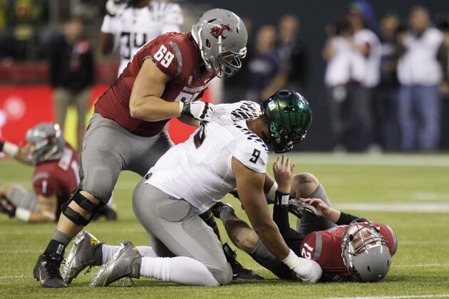 Washington State's Jake Rodgers, (69) pulls Oregon's Arik Armstead off of Washington State quarterback Connor Halliday (12) during an NCAA college football game, Saturday, Sept. 29, 2012, in Seattle. (AP Photo/Ted S. Warren)