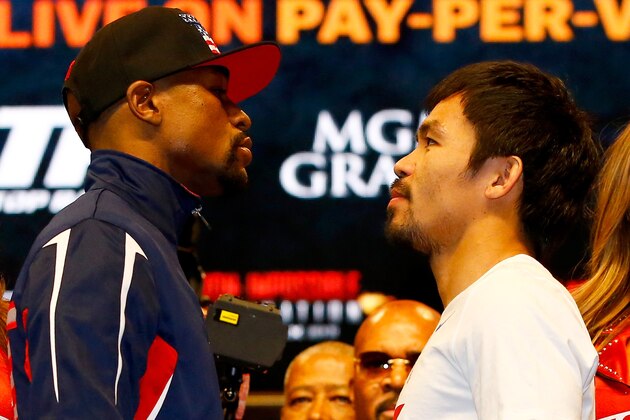 LAS VEGAS, NV - MAY 01: Floyd Mayweather Jr. (L) and Manny Pacquiao face off during their official weigh-in on May 1, 2015 at MGM Grand Garden Arena in Las Vegas, Nevada. The two will face each other in a welterweight unification bout on May 2, 2015 in Las Vegas. (Photo by Al Bello/Getty Images) LAS VEGAS, NV - MAY 01: Floyd Mayweather Jr. (L) and Manny Pacquiao face off during their official weigh-in on May 1, 2015 at MGM Grand Garden Arena in Las Vegas, Nevada. The two will face each other in a welterweight unification bout on May 2, 2015 in Las Vegas. (Photo by Al Bello/Getty Images)