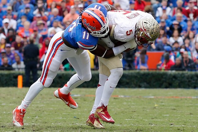 GAINESVILLE, FL - NOVEMBER 30:  Neiron Ball #11 of the Florida Gators tackles Jameis Winston #5 of the Florida State Seminoles  during the game on November 30, 2013 in Gainesville, Florida.  (Photo by Sam Greenwood/Getty Images)