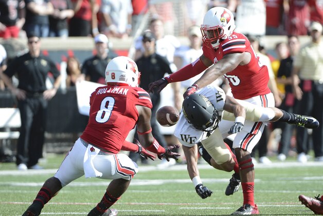 Sep 27, 2014; Louisville, KY, USA; Louisville Cardinals safety Gerod Holliman (8) intercepts a pass intended for Wake Forest Demon Deacons wide receiver E.J. Scott (17) during the second quarter at Papa John's Cardinal Stadium. Mandatory Credit: Jamie Rhodes-USA TODAY Sports