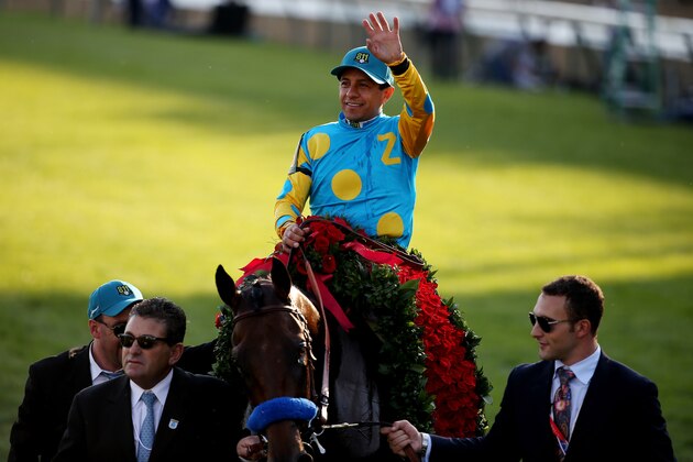 LOUISVILLE, KY - MAY 02:  Jockey Victor Espinoza celebrates atop of American Pharoah #18 on his way winners circle after winning the 141st running of the Kentucky Derby at Churchill Downs on May 2, 2015 in Louisville, Kentucky.  (Photo by Andy Lyons/Getty Images)