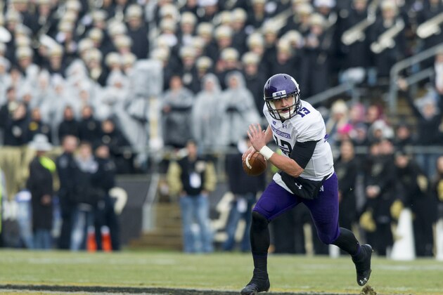 Northwestern's Trevor Siemian (13) runs out of the backfield with the ball during the first half of an NCAA college football game, Saturday, Nov. 22, 2014, in West Lafayette, Ind. (AP Photo/Doug McSchooler)