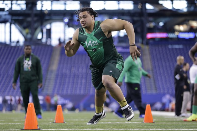 Fresno State defensive lineman Tyeler Davison runs a drill at the NFL football scouting combine in Indianapolis, Sunday, Feb. 22, 2015. (AP Photo/Julio Cortez)