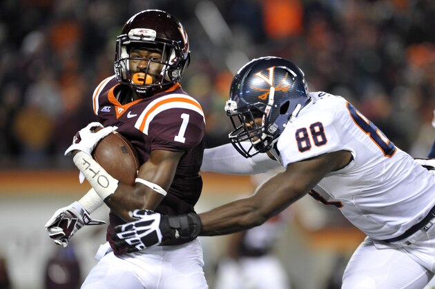 BLACKSBURG, VA - NOVEMBER 28: Wide receiver Isaiah Ford #1 of the Virginia Tech Hokies carries the ball on a reverse while outside linebacker Max Valles #88 of the Virginia Cavaliers attempts the tackle in the first half at Lane Stadium on November 28, 2014 in Blacksburg, Virginia. Virginia Tech defeated Virginia 24-20. (Photo by Michael Shroyer/Getty Images)