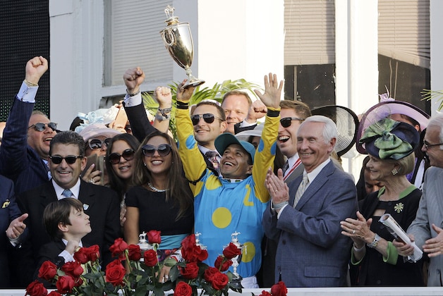 Victor Espinoza celebrates after riding American Pharoah to victory in the 141st running of the Kentucky Derby horse race at Churchill Downs Saturday, May 2, 2015, in Louisville, Ky. (AP Photo/Garry Jones)