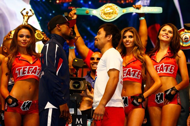 LAS VEGAS, NV - MAY 01:  Floyd Mayweather Jr. (L) and Manny Pacquiao face off during their official weigh-in on May 1, 2015 at MGM Grand Garden Arena in Las Vegas, Nevada. The two will face each other in a welterweight unification bout on May 2, 2015 in Las Vegas.  (Photo by Al Bello/Getty Images)