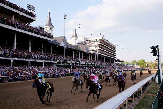 LOUISVILLE, KY - MAY 02:  Jockey Victor Espinoza celebrates as he guides American Pharoah #18 after crossing the finish line to win the 141st running of the Kentucky Derby at Churchill Downs on May 2, 2015 in Louisville, Kentucky.  (Photo by Rob Carr/Getty Images)