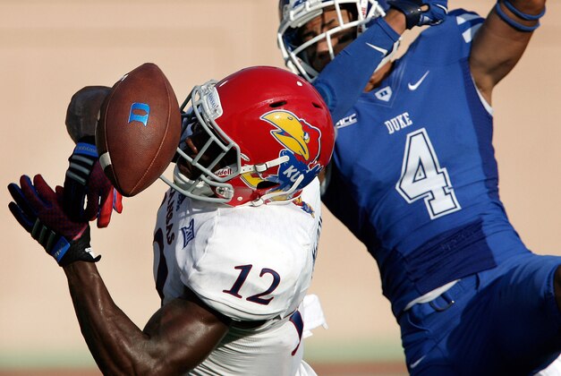 Sep 13, 2014; Durham, NC, USA; Kansas Jayhawks cornerback Dexter McDonald (12) breaks up the pass to Duke Blue Devils wide receiver Johnell Barnes (4) at Wallace Wade Stadium. Mandatory Credit: Mark Dolejs-USA TODAY Sports