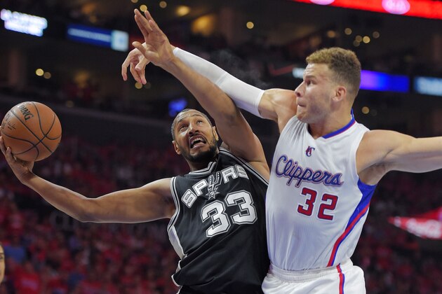 San Antonio Spurs center Boris Diaw, left, of France, shoots as Los Angeles Clippers forward Blake Griffin defends during the first half of Game 7 in a first-round NBA basketball playoff series, Saturday, May 2, 2015, in Los Angeles. (AP Photo/Mark J. Terrill)