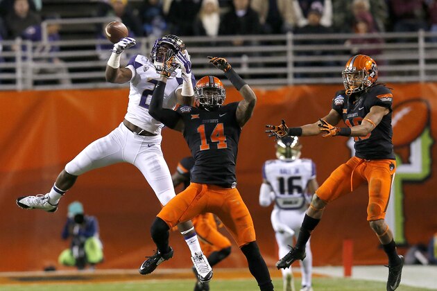 Washington wide receiver Kasen Williams (2) and Oklahoma State linebacker Josh Furman (14) battle for the ball in the first half during the Cactus Bowl NCAA college football game, Friday, Jan. 2, 2015, in Tempe, Ariz. (AP Photo/Rick Scuteri)