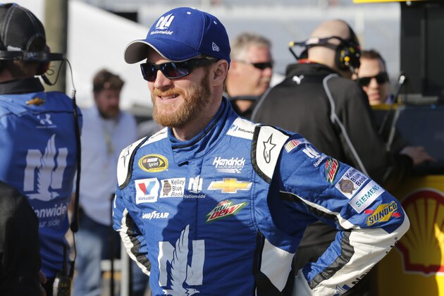 Driver Dale Earnhardt Jr., waits to get into his car prior to the start of qualifying Friday, April 24, 2015, for Saturday's NASCAR Sprint Cup auto race at Richmond International Raceway in Richmond, Va.  (AP Photo/Steve Helber)