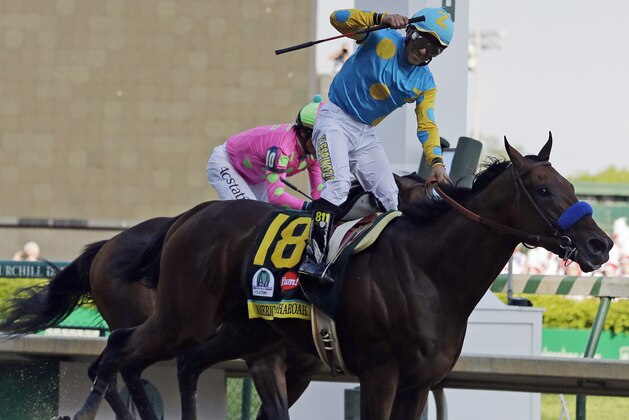 Victor Espinoza rides American Pharoah to victory in the 141st running of the Kentucky Derby horse race at Churchill Downs Saturday, May 2, 2015, in Louisville, Ky. (AP Photo/Brynn Anderson)