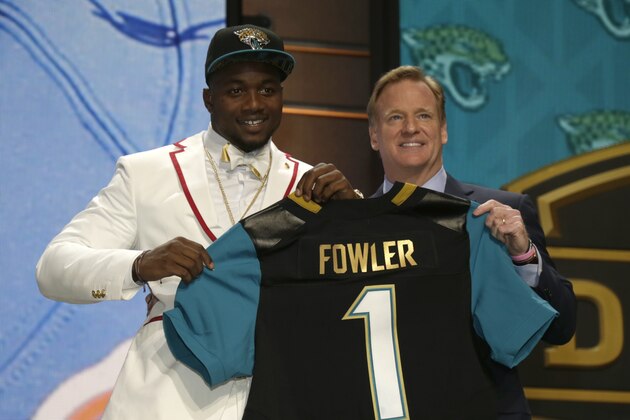 Dante Fowler, left, stands with NFL commissioner Roger Goodell, right, on stage after being drafted third by Jacksonville in the first round of the 2015 NFL Draft, Thursday, April 30, 2015, in Chicago.  (Jeff Haynes/AP Images for Panini)