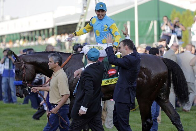 Victor Espinoza reacts after riding American Pharoah to victory in the 141st running of the Kentucky Derby horse race at Churchill Downs Saturday, May 2, 2015, in Louisville, Ky.  (AP Photo/David J. Phillip)