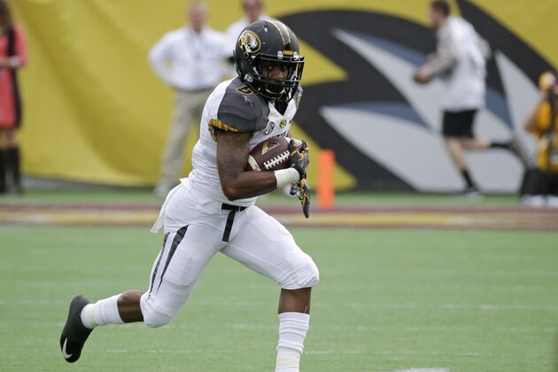 Missouri running back Marcus Murphy gains yardage against Minnesota during the first half of the Citrus Bowl NCAA college football game in Orlando, Fla., Thursday, Jan. 1, 2015. (AP Photo/John Raoux)