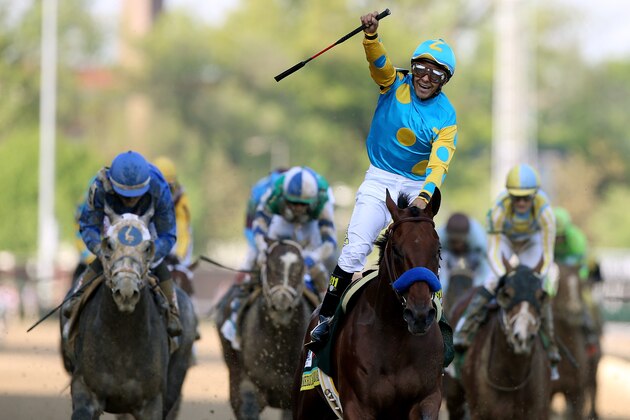 LOUISVILLE, KY - MAY 02:  Jockey Victor Espinoza celebrates as he guides American Pharoah #18 after crossing the finish line to win the 141st running of the Kentucky Derby at Churchill Downs on May 2, 2015 in Louisville, Kentucky.  (Photo by Chris Graythen/Getty Images)