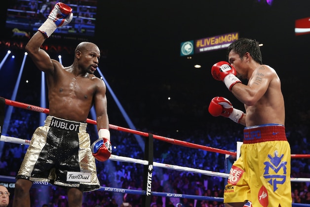 Floyd Mayweather Jr., left, celebrates during his welterweight title fight against Manny Pacquiao, from the Philippines, on Saturday, May 2, 2015 in Las Vegas. (AP Photo/John Locher)