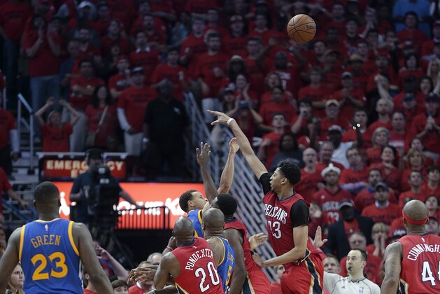 FILE - In this April 23, 2015, file photo, Golden State Warriors guard Stephen Curry (30) shoots a 3-point basket over New Orleans Pelicans forward Anthony Davis (23) to tie the game in the final seconds of the second half of Game 3 of a first-round NBA basketball playoff series in New Orleans. Curry's tying 3-pointer could have been a four-point play. The NBA says a foul should have been called on Curry's 3-pointer with 3.5 seconds left in regulation Thursday night. Golden State went on to beat New Orleans 123-119 in overtime for a 3-0 lead in its series. (AP Photo/Gerald Herbert, File)
