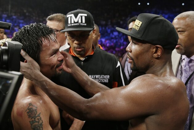 Manny Pacquiao, from the Philippines, left, and Floyd Mayweather Jr., embrace in the ring at the finish of their welterweight title fight on Saturday, May 2, 2015 in Las Vegas. (AP Photo/Isaac Brekken)