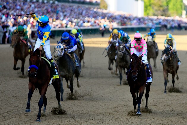 LOUISVILLE, KY - MAY 02:  Jockey Victor Espinoza celebrates as he guides American Pharoah #18 after crossing the finish line to win the 141st running of the Kentucky Derby at Churchill Downs on May 2, 2015 in Louisville, Kentucky.  (Photo by Rob Carr/Getty Images)