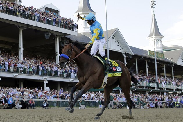 Victor Espinoza rides American Pharoah to victory in the 141st running of the Kentucky Derby horse race at Churchill Downs Saturday, May 2, 2015, in Louisville, Ky. (AP Photo/David J. Phillip)