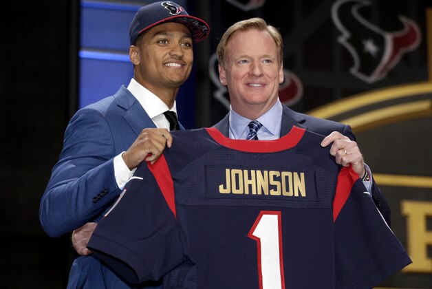 Kevin Johnson stands on stage with NFL commissioner Roger Goodell, right, after being drafted 16th by the Houston Texans in the first round of the 2015 NFL Draft, Thursday, April 30, 2015, in Chicago.  (Jeff Haynes/AP Images for Panini)