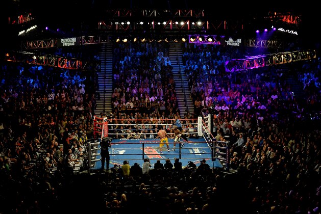 LAS VEGAS, NV - MAY 02:  Floyd Mayweather Jr. throws a right at Manny Pacquiao during their welterweight unification championship bout on May 2, 2015 at MGM Grand Garden Arena in Las Vegas, Nevada.  (Photo by Harry How/Getty Images)
