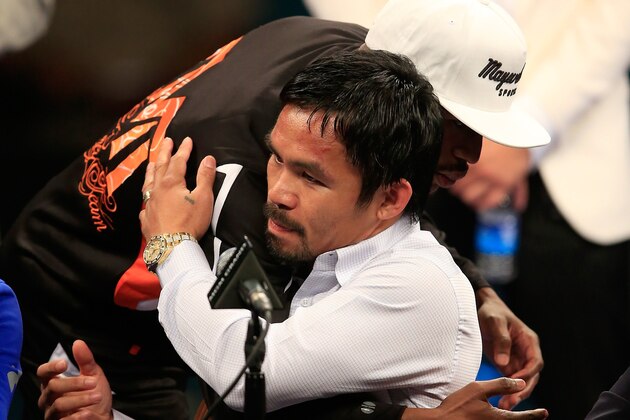 LAS VEGAS, NV - MAY 02:  Floyd Mayweather hugs Manny Pacquiao during their post-fight news conference after Mayweather Jr.'s unanimous decision victory in their welterweight unification championship bout on May 2, 2015 at MGM Grand Garden Arena in Las Vegas, Nevada.  (Photo by Jamie Squire/Getty Images)