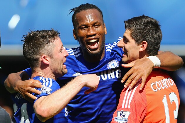 LONDON, ENGLAND - MAY 03:  Gary Cahill, Didier Drogba and Thibaut Courtois of Chelsea celebrate winning the Premier League title after the Barclays Premier League match between Chelsea and Crystal Palace at Stamford Bridge on May 3, 2015 in London, England. Chelsea became champions with a 1-0 victory.  (Photo by Clive Mason/Getty Images)