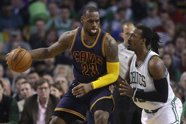 Cleveland Cavaliers forward LeBron James, left, looks for an opening around Boston Celtics forward Gerald Wallace, right, in the second quarter of a first-round NBA playoff basketball game in Boston, Sunday, April 26, 2015. The Cavaliers won 101-93 to complete a first-round sweep of the Celtics. (AP Photo/Steven Senne)