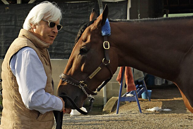 Hall of Fame trainer Bob Baffert, left, feeds Kentucky Derby winner American Pharoah a carrot at Churchill Downs in Louisville, Ky., Sunday, May 3, 2015. Baffert won his fourth Derby, and first since 2002.  (AP Photo/Garry Jones)