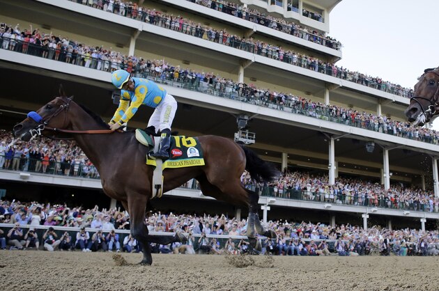 Victor Espinoza rides American Pharoah to victory in the 141st running of the Kentucky Derby horse race at Churchill Downs Saturday, May 2, 2015, in Louisville, Ky. (AP Photo/David J. Phillip)