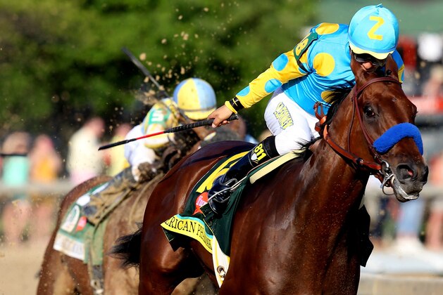 LOUISVILLE, KY - MAY 02:  American Pharoah #18, ridden by Victor Espinoza, comes out of turn 4 during the 141st running of the Kentucky Derby at Churchill Downs on May 2, 2015 in Louisville, Kentucky.  (Photo by Andy Lyons/Getty Images)