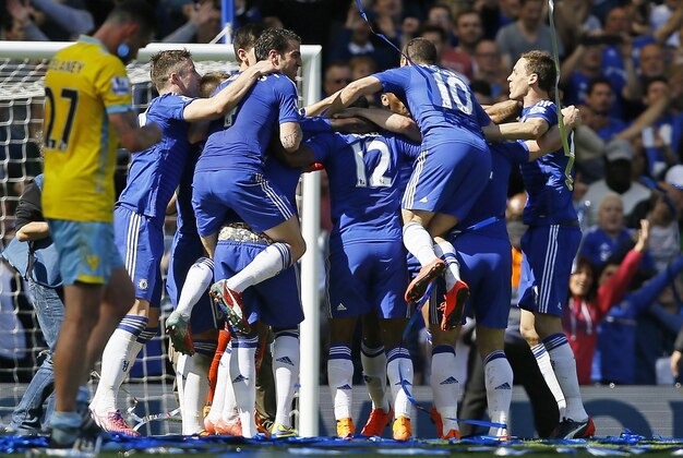 Chelsea players celebrate after the English Premier League soccer match between Chelsea and Crystal Palace at Stamford Bridge stadium in London, Sunday, May 3, 2015.  Chelsea won the match 1-0 to secure Premier League title with 3 games to spare.  (AP Photo/Kirsty Wigglesworth)
