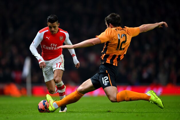 LONDON, ENGLAND - JANUARY 04:  Alexis Sanchez of Arsenal battles for the ball with Harry Maguire of Hull City during the FA Cup Third Round match between Arsenal and Hull City at Emirates Stadium on January 4, 2015 in London, England.  (Photo by Paul Gilham/Getty Images)