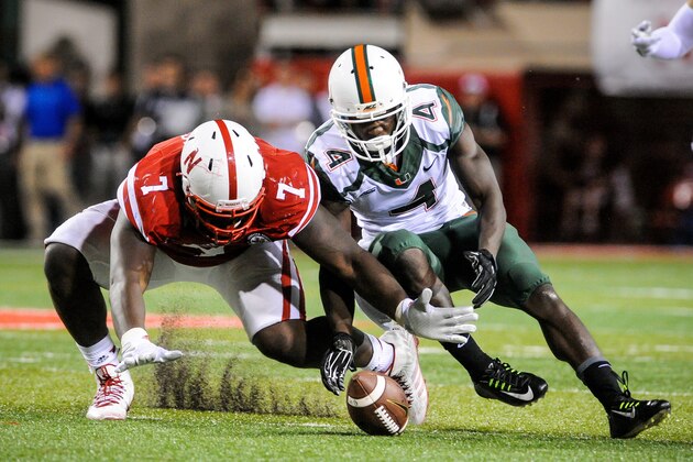LINCOLN, NE - SEPTEMPER 20: Defensive tackle Maliek Collins #7 of the Nebraska Cornhuskers and wide receiver Phillip Dorsett #4 of the Miami Hurricanes fight for a loose ball during their game at Memorial Stadium on September 20, 2014 in Lincoln, Nebraska. Nebraska defeated Miami 41-31. (Photo by Eric Francis/Getty Images)