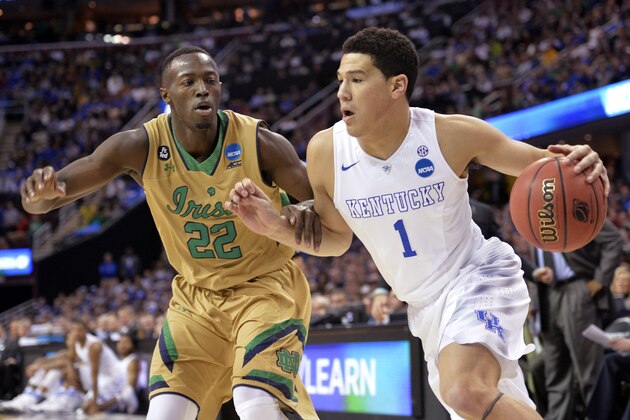 Kentucky's Devin Booker (1) drives on Notre Dame's Jerian Grant (22) during the first half of a college basketball game in the NCAA men's tournament regional finals, Saturday, March 28, 2015, in Cleveland. (AP Photo/David Richard)