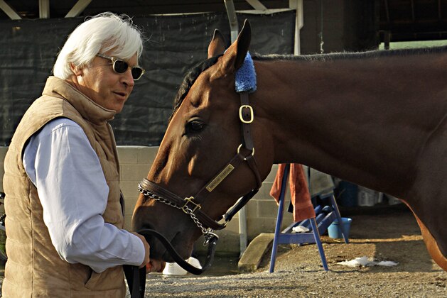 Hall of Fame trainer Bob Baffert, left, feeds Kentucky Derby winner American Pharoah a carrot at Churchill Downs in Louisville, Ky., Sunday, May 3, 2015. Baffert won his fourth Derby, and first since 2002.  (AP Photo/Garry Jones)