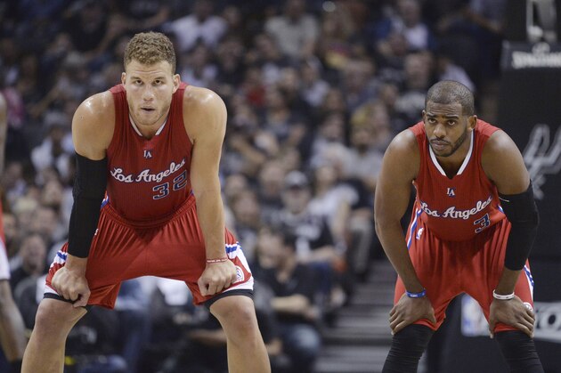 Los Angeles Clippers' Blake Griffin (32) and Chris Paul (3) wait for play to resume during the first half of Game 3 in an NBA basketball first-round playoff series against the San Antonio Spurs, Friday, April 24, 2015, in San Antonio. (AP Photo/Darren Abate)