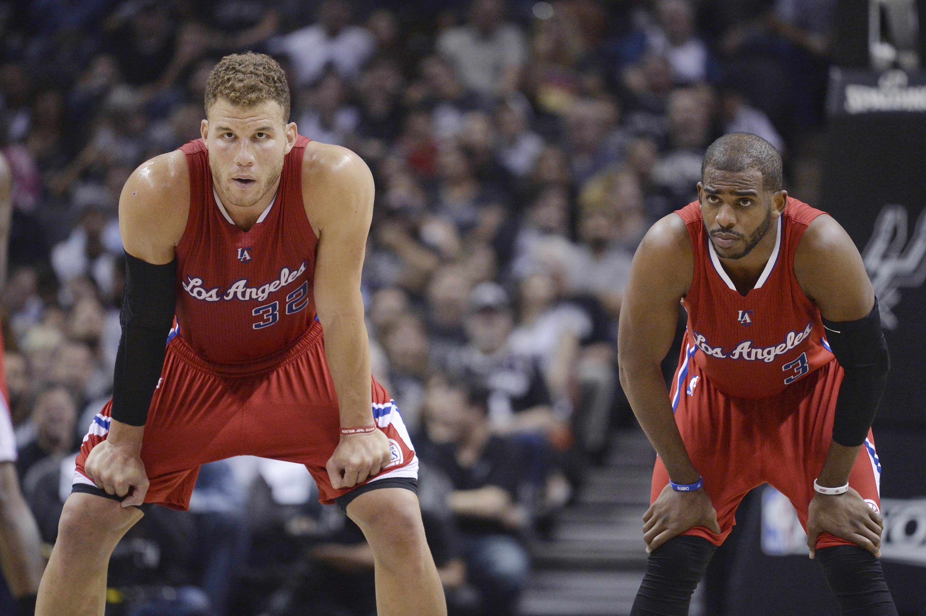 Los Angeles Clippers' Blake Griffin (32) and Chris Paul (3) wait for play to resume during the first half of Game 3 in an NBA basketball first-round playoff series against the San Antonio Spurs, Friday, April 24, 2015, in San Antonio. (AP Photo/Darren Abate)
