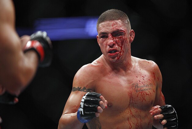 Oct 19, 2013; Houston, TX, USA; Gilbert Melendez (red gloves) fights against Diego Sanchez (blue gloves) in their lightweight bout during UFC 166 at Toyota Center. Mandatory Credit: Andrew Richardson-USA TODAY Sports