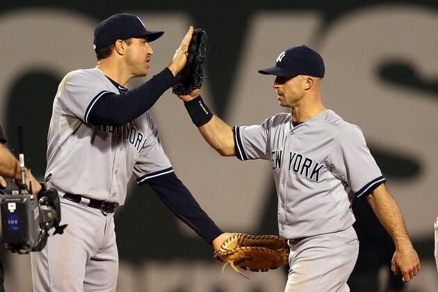 BOSTON, MA - MAY 3:  Mark Teixeira #25 of the New York Yankees and teammate Brett Gardner #11 of the New York Yankees celebrate their 8-5 win over the Boston Red Sox at Fenway Park May 3, 2015 in Boston, Massachusetts.  (Photo by Jim Rogash/Getty Images)