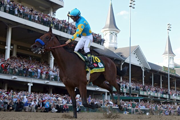 LOUISVILLE, KY - MAY 02:  Jockey Victor Espinoza celebrates as he guides American Pharoah #18 after crossing the finish line to win the 141st running of the Kentucky Derby at Churchill Downs on May 2, 2015 in Louisville, Kentucky.  (Photo by Rob Carr/Getty Images)