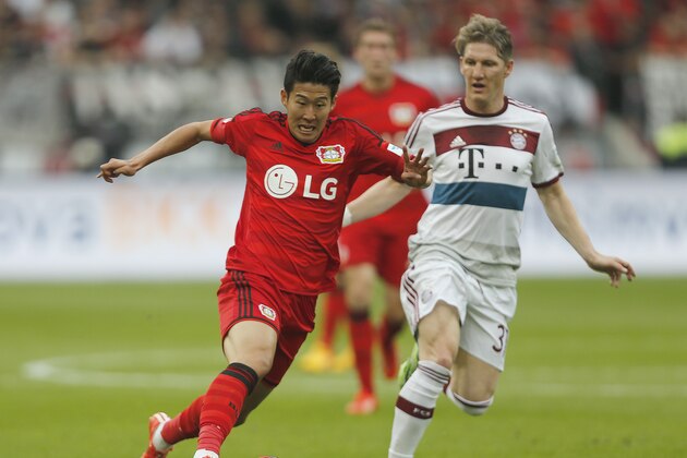 Leverkusen's Son Heung-min, left, and Bayern's Bastian Schweinsteiger challenge for the ball during the German first division Bundesliga soccer match between Bayer 04 Leverkusen and Bayern Munich in Leverkusen, Germany, Saturday, May 2, 2015. (AP Photo/Frank Augstein)