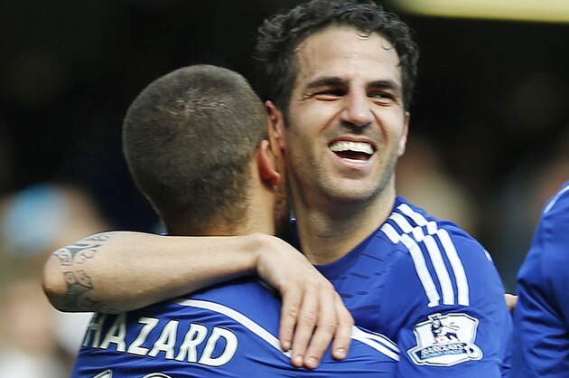 Chelsea's Eden Hazard, left, embraces Cesc Fabregas after the English Premier League soccer match between Chelsea and Crystal Palace at Stamford Bridge stadium in London, Sunday, May 3, 2015.  Chelsea won the match 1-0 to secure Premier League title with 3 games to spare. (AP Photo/Alastair Grant)