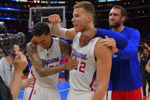 Los Angeles Clippers forward Matt Barnes, left, celebrates with forward Blake Griffin, center, and forward Spencer Hawes after they defeated the San Antonio Spurs in Game 7 in a first-round NBA basketball playoff series, Saturday, May 2, 2015, in Los Angeles. The Clippers won 111-109. (AP Photo/Mark J. Terrill)